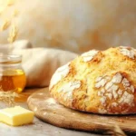 Rustic Golden Einkorn Bread recipe On A Wooden Board With Butter And Honey.
