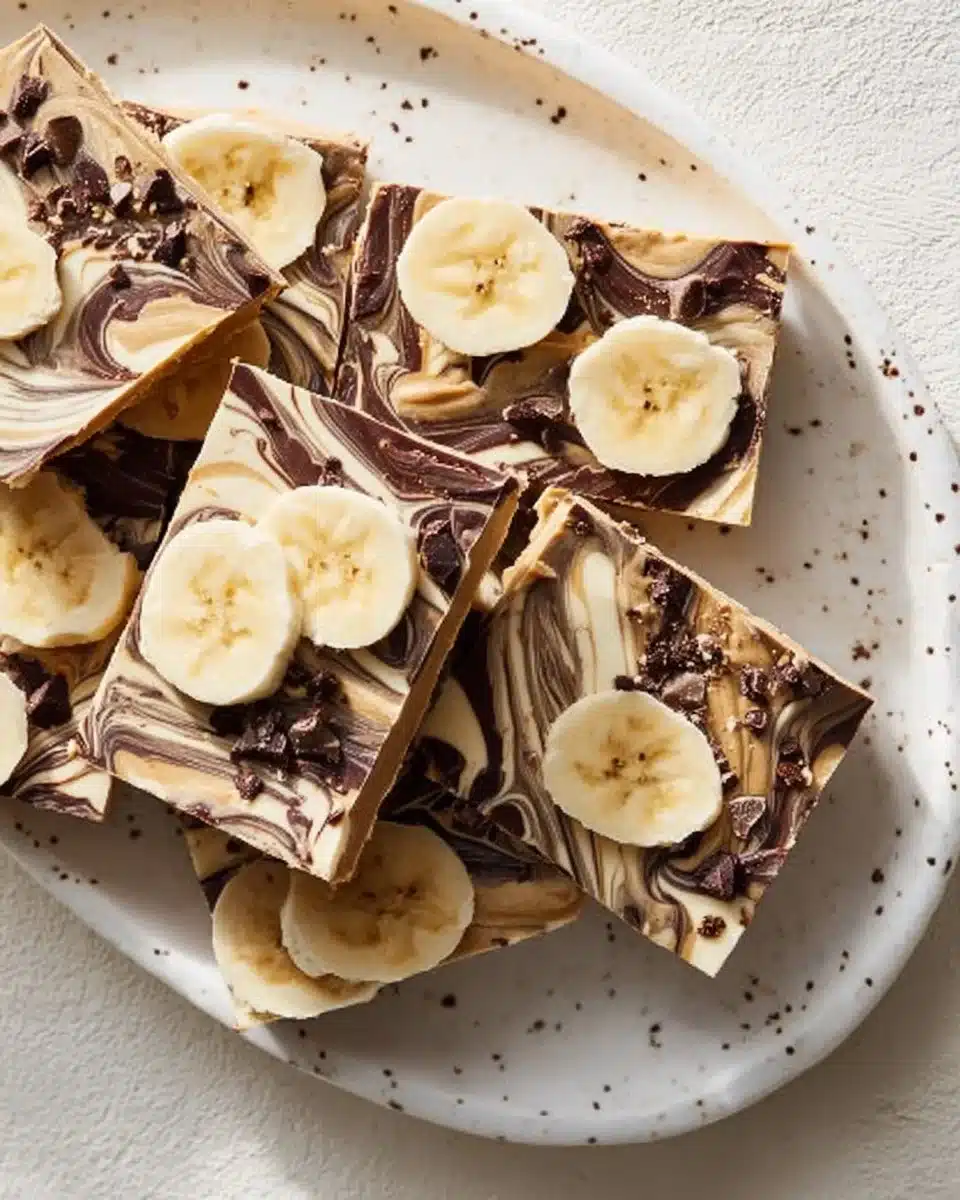 Frozen Peanut Butter Chocolate Greek Yogurt Bark topped with nuts and chocolate
