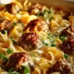 Delicious Swedish meatball noodle bake topped with cheese and herbs