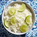 Delicious bowl of Coconut Lime Rice with fresh lime and coconut flakes