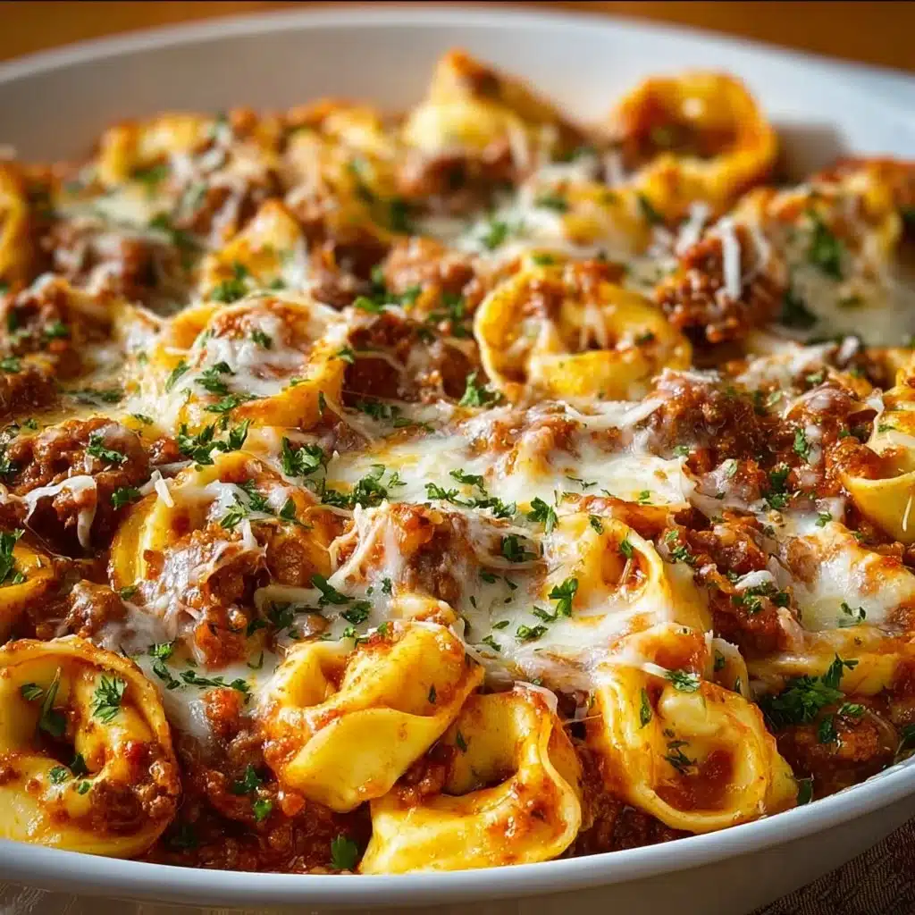 Creamy Italian Sausage Tortellini Bake casserole dish topped with cheese