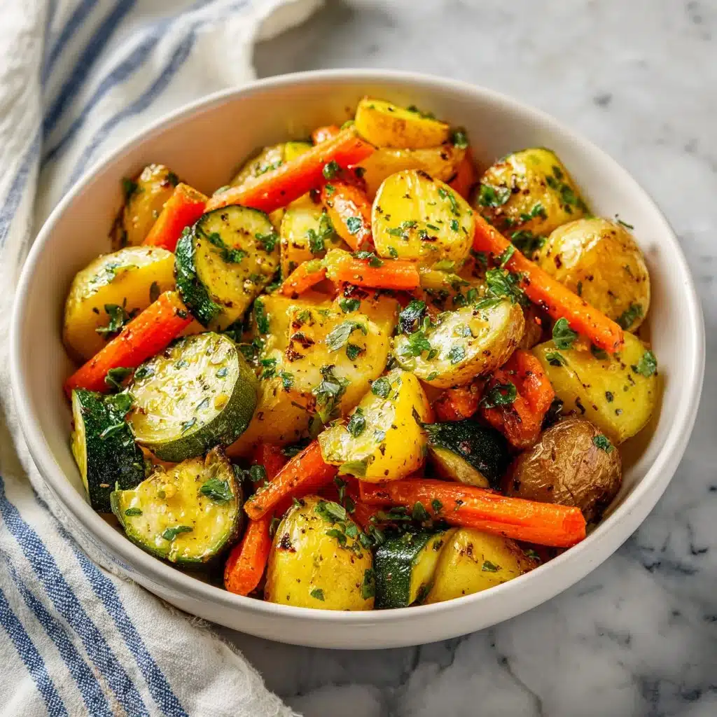 Garlic herb roasted potatoes, carrots, and zucchini on a serving platter.