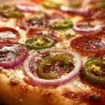 Savory pepperoncini and onion vegetarian pizza on a wooden table