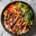 Delicious sticky chicken bowls with vegetables and rice