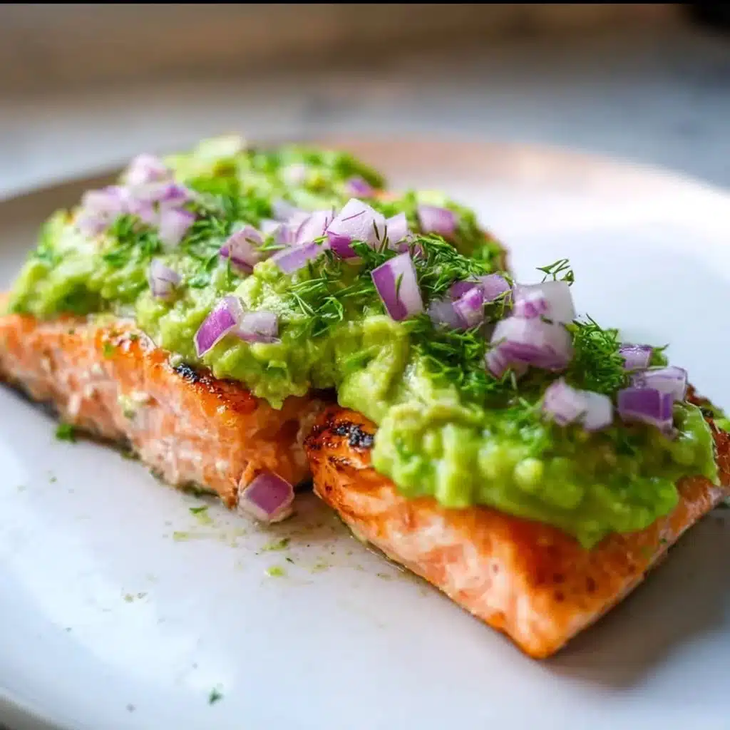 Delicious baked salmon garnished with creamy avocado mash