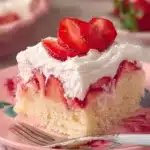 Valentine's Day Poke Cake with frosting and heart decorations