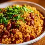 Delicious bowl of authentic Puerto Rican Rice and Beans served with fresh herbs.