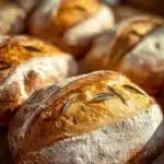 Loaves of freshly baked homemade Italian bread on a wooden table