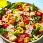 A colorful bowl of Italian Grinder Salad with fresh vegetables and toppings