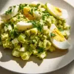 Mediterranean avocado egg salad served in a bowl with fresh ingredients