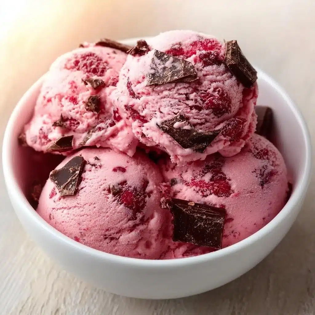 Delicious raspberry chocolate chunk ice cream scooped in a bowl