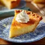 Slice of Southern buttermilk pie on a plate with a fork