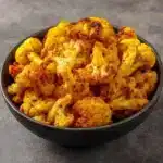 Turmeric Spice Roasted Cauliflower on a plate garnished with herbs