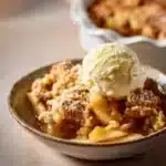 Delicious apple cinnamon cobbler topped with a golden crust and cinnamon sprinkles