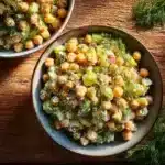 Chickpea salad with fresh dill and colorful vegetables served in a bowl.
