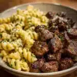 Delicious Garlic Butter Steak Bites served with Cheesy Alfredo Twists