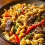 High-Protein Philly Cheesesteak Mac dish topped with melted cheese