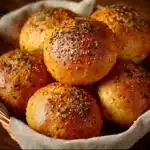 Freshly baked red lentil bread rolls on a wooden table