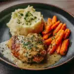 Creamy garlic chicken served with mashed potatoes and glazed carrots