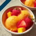 Delicious mango strawberry sorbet in a bowl, perfect summer dessert.
