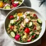 A vibrant Spring Quinoa Salad with fresh vegetables and herbs.
