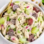 High-protein Greek yogurt chicken salad with fresh ingredients and herbs.