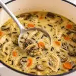 Delicious Macro-Friendly Creamy Chicken & Wild Rice Soup with vegetables and herbs.