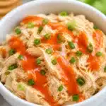 High-Protein Buffalo Chicken Salad Bowl with shredded chicken, greens, and ranch dressing.