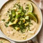 Bowl of Whole30 White Chicken Chili with fresh toppings