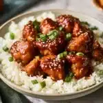 Delicious crispy sesame chicken served with vegetables and sauce
