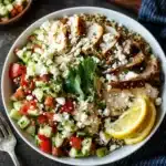 High-Protein Mediterranean Chickpea & Grilled Chicken Quinoa Bowl with fresh vegetables.
