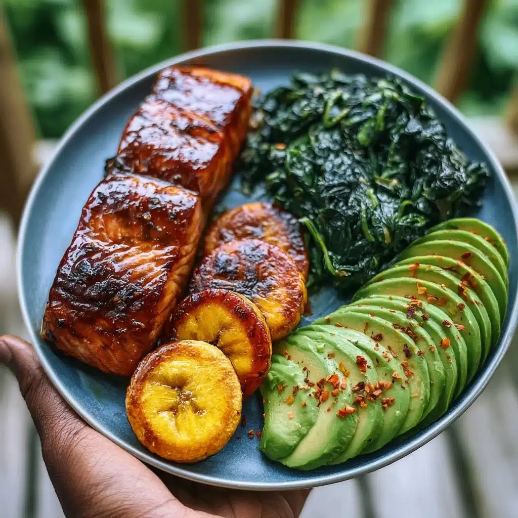 Plate of herb-glazed salmon with sweet plantains, sautéed spinach, and avocado