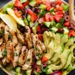 High-Protein Lemon Herb Grilled Chicken Salad with fresh vegetables and herbs.